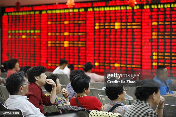 Investors watche the eclectic monitor at a stock exchange in Huaibei , Anhui province, China on June 1 2015.The Shanghai Composite was turbo-charged...