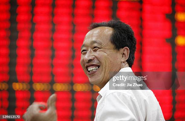 An investor watches the eclectic monitor at a stock exchange in Huaibei , Anhui province, China on June 1 2015.The Shanghai Composite was...