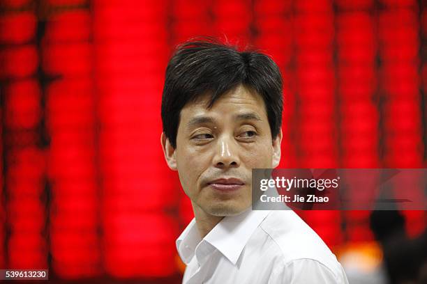 An investor watches the eclectic monitor at a stock exchange in Huaibei , Anhui province, China on June 1 2015.The Shanghai Composite was...