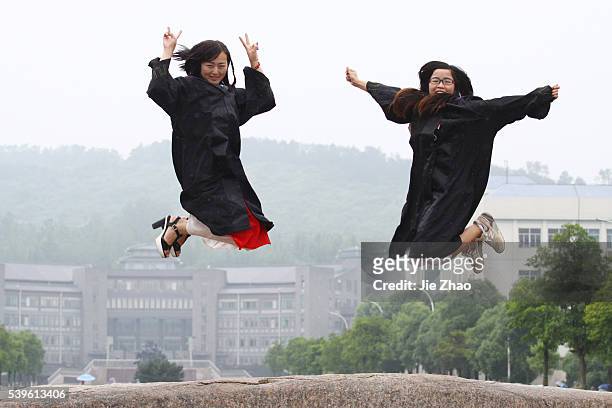 Femle students pose for graduating photograph at a university in Xiangyang, Hubei province, China on 3th June 2015.