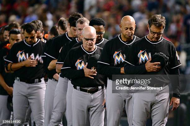 Manager Don Mattingly of the Miami Marlins stands with his team to observe a moment of silence for the victims in the Pulse nightclub terror attack...