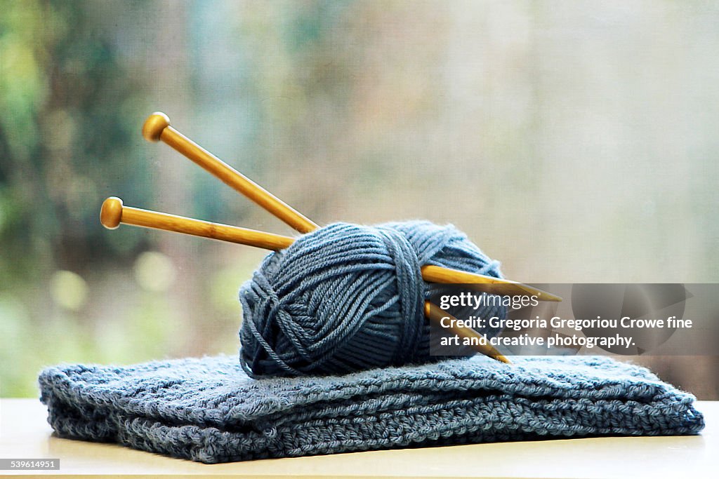 Knitting needles in ball of yarn