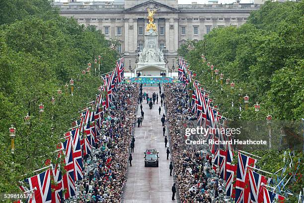 Queen Elizabeth II and Prince Philip, Duke of Edinburgh take part in a parade down The Mall during 'The Patron's Lunch' celebrations for The Queen's...