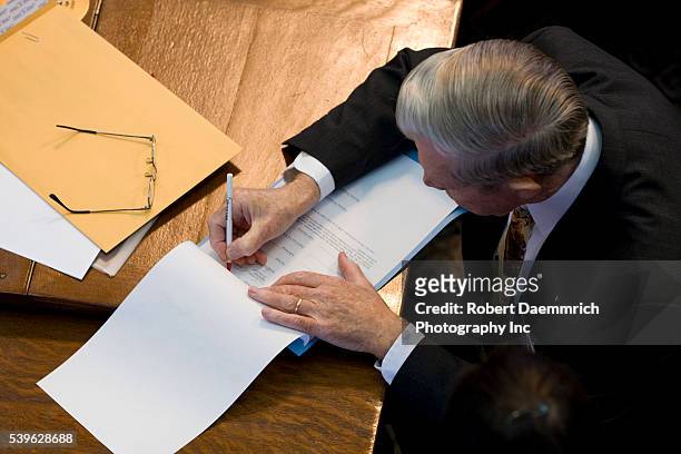 Texas Electoral College members certify their signatures as the Electoral College meets at the Texas Capitol in Austin, where 34 Republican electors...