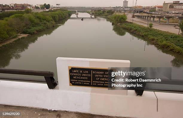 The United States boundary with Mexico as seen from the center of International Bridge, looking west in downtown Laredo, TX. Nuevo Laredo, Mexico is...