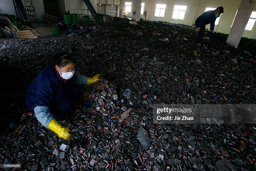 Workers sort batteries in an electronic waste recycling factory in Wuhan, Hubei province