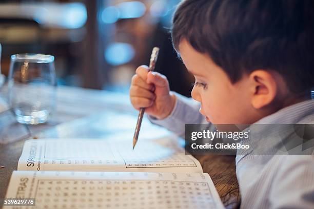 little kid making a wordsearch - alphabet soup stock pictures, royalty-free photos & images