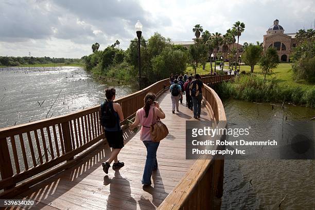 College students walk across the resaca that once was the Rio Grande River at the University of Texas-Brownsville and Texas Southmost College campus.