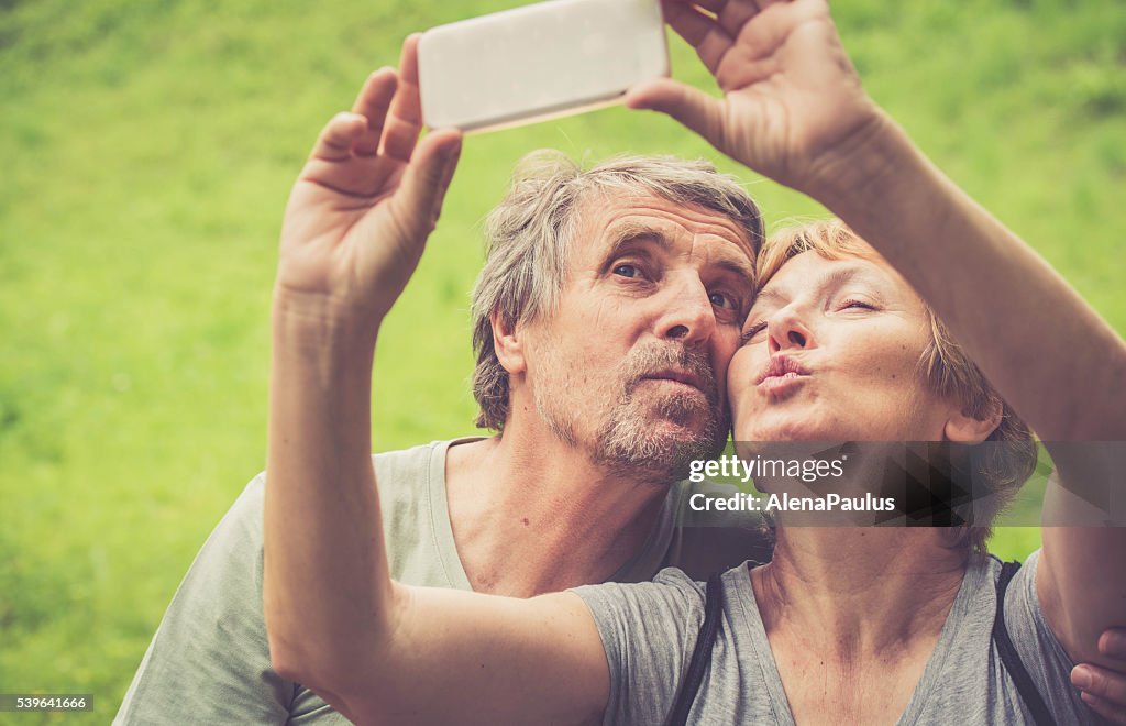 Beautiful senior caucasian couple taking selfie - duck face