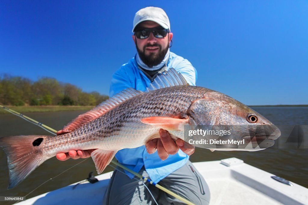 Fisherman with a large redfish
