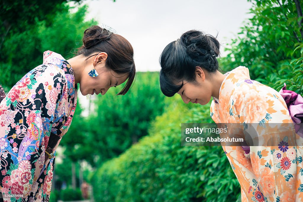 Beautiful Japanese Women in Kimono Bowing, Kyoto, Japan