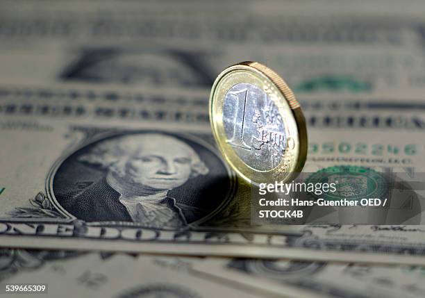 dollar bills and euro coin - one euro coin stock pictures, royalty-free photos & images