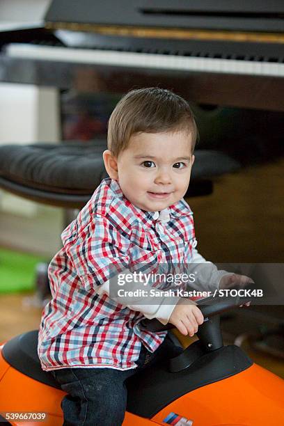 toddler at home on push car - bobbycar stockfoto's en -beelden