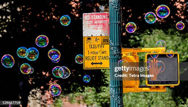 usa, new york state, new york city, road sign with soap bubbles - pedestrian crossing light stock pictures, royalty-free photos & images