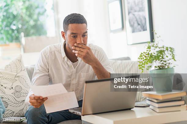 usa, new jersey, man paying bills online - paperwork frustration stock pictures, royalty-free photos & images