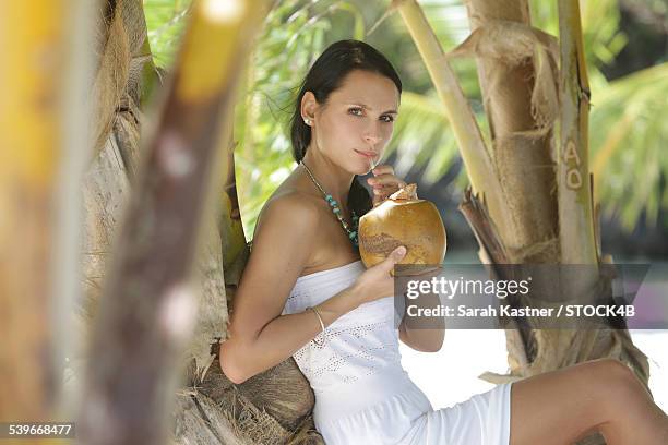 woman drinking from coconut, playa rincon, dominican republic - coconut beach woman stock pictures, royalty-free photos & images