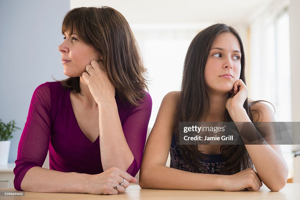 USA, New Jersey, Frustrated teenage girl (14-15) and her mom sitting at table