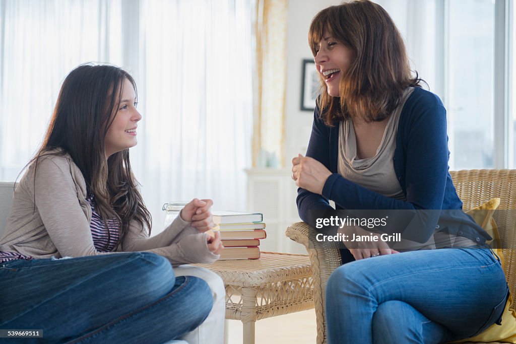 USA, New Jersey, Teenage girl (14-15) talking with her mom in living room