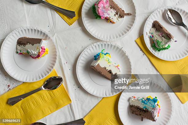 slices of cake on plates - birthday cake overhead stock pictures, royalty-free photos & images