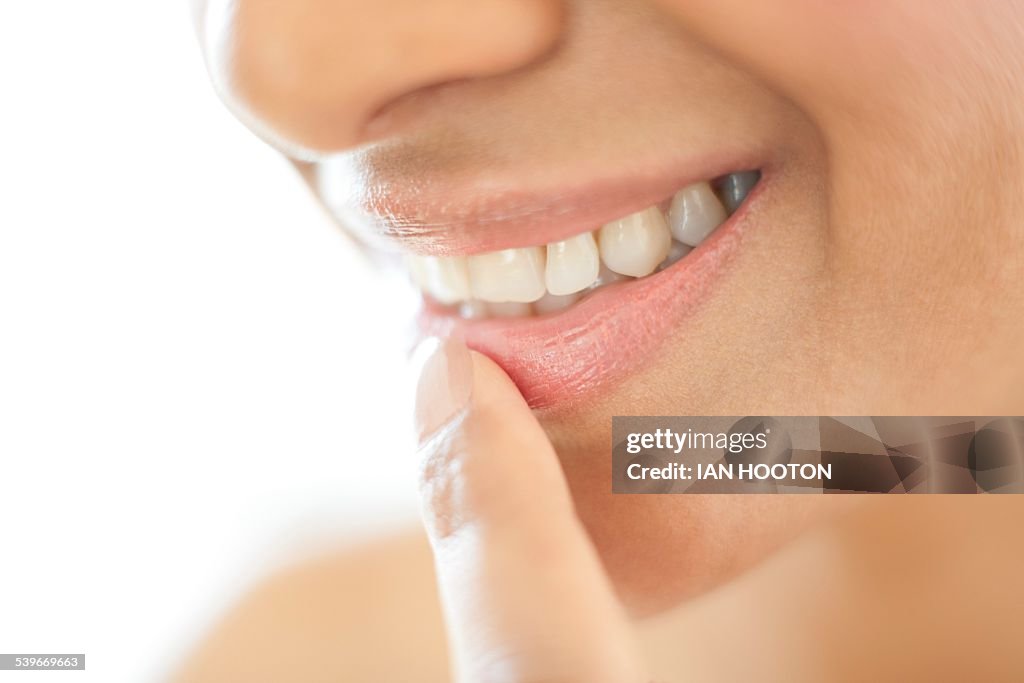 Woman with her finger on her lip