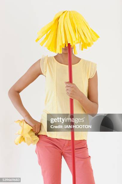 woman holding mop in front of face - staubwedel stock-fotos und bilder