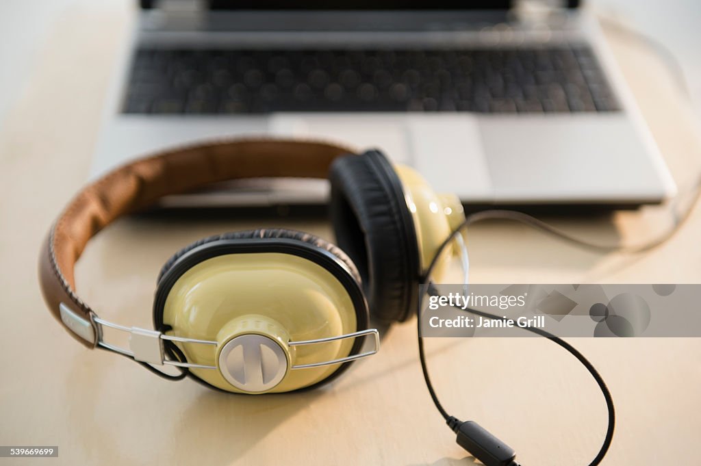 Headphones and laptop on table