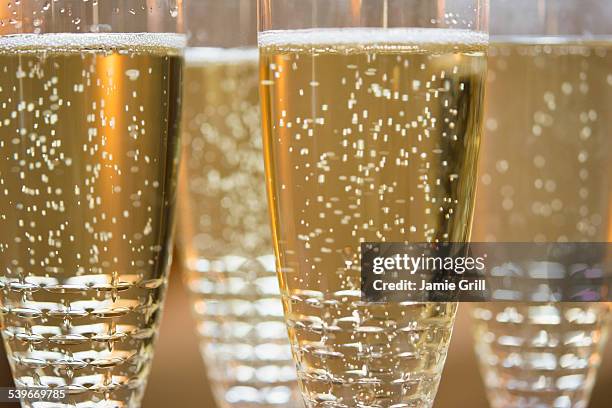 close-up of champagne flutes - bulles champagne photos et images de collection