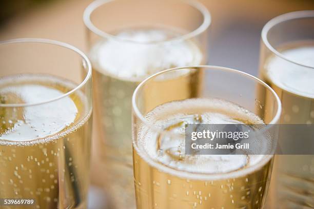 elevated view of champagne flutes - bulles champagne photos et images de collection