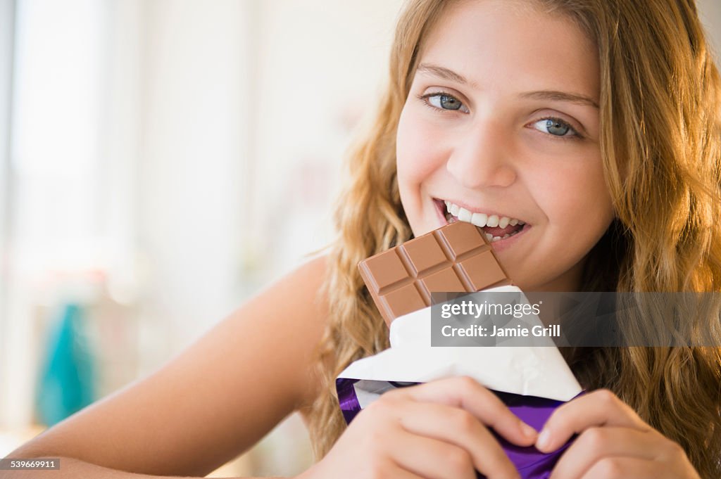 USA, New Jersey, Girl (12-13) eating chocolate