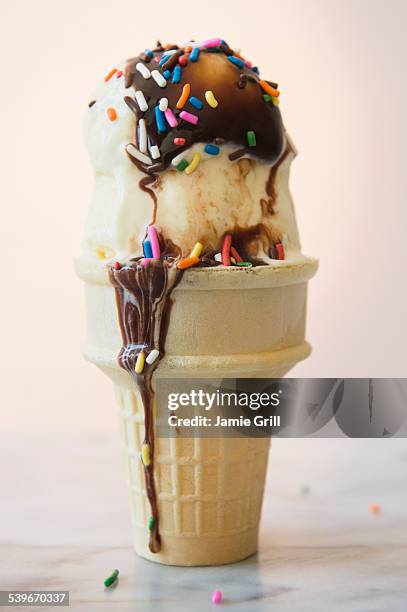 studio shot of ice cream cone with chocolate sauce - ice cream sundae fotografías e imágenes de stock