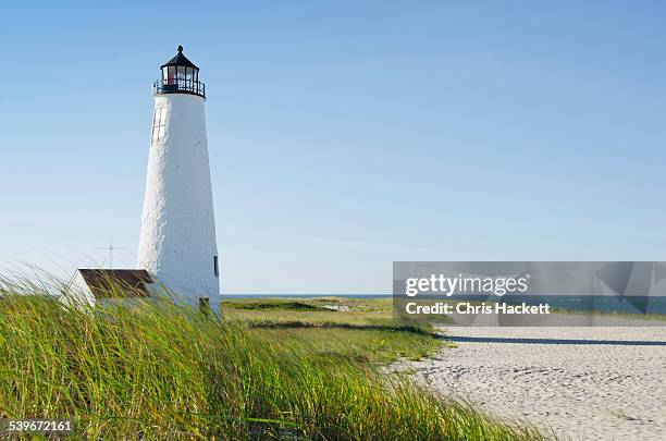 usa, massachusetts, nantucket, great point lighthouse on overgrown beach against clear sky - new england usa photos et images de collection