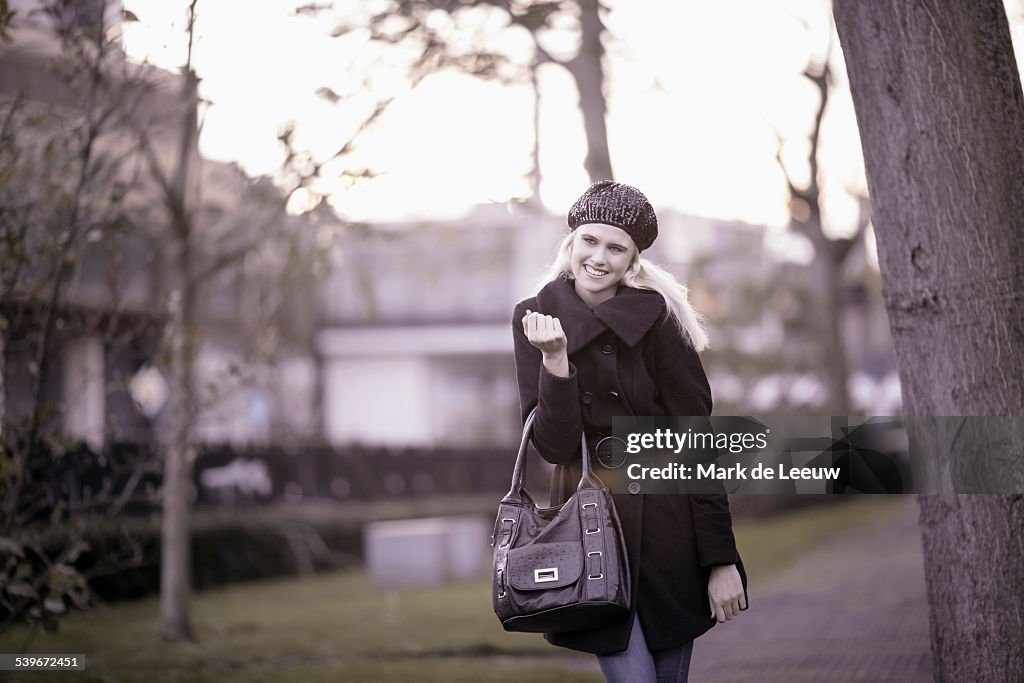 Netherlands, Tilburg, Smiling woman walking in park