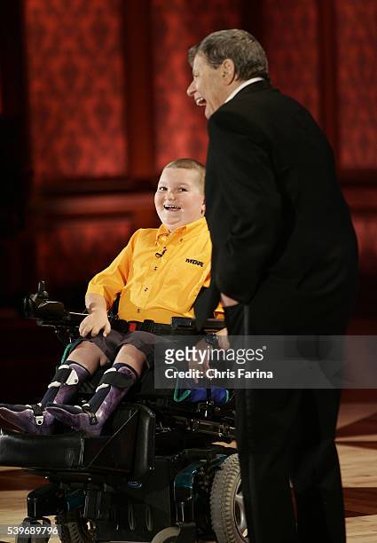 Host Jerry Lewis talks with the Muscular Dystrophy Association's national goodwill ambassador Luke Christie during the 42nd Annual Jerry Lewis MDA...