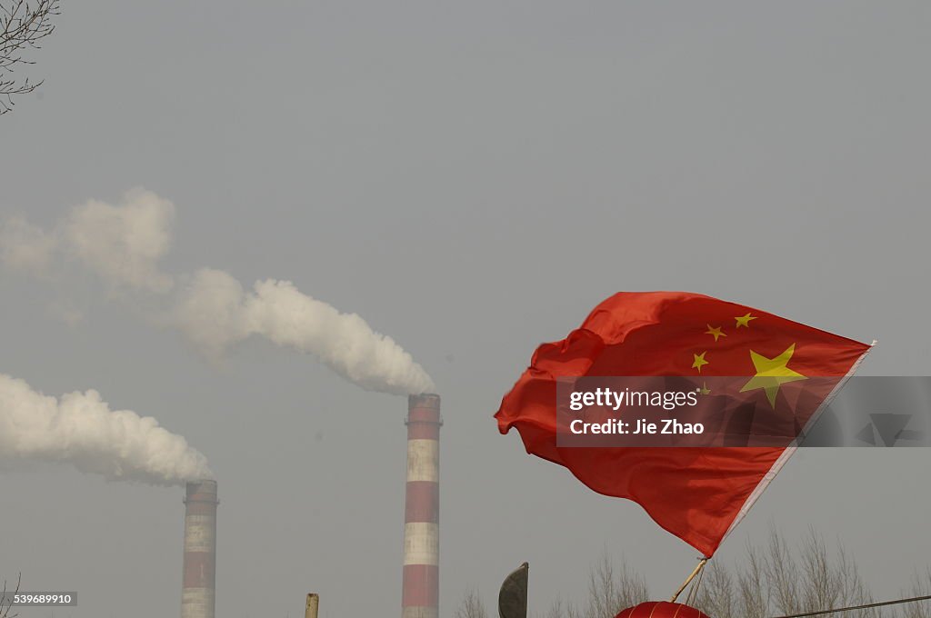 Stacks of a heat power plant are seen on the outskirts of Changzhi, Shanxi province