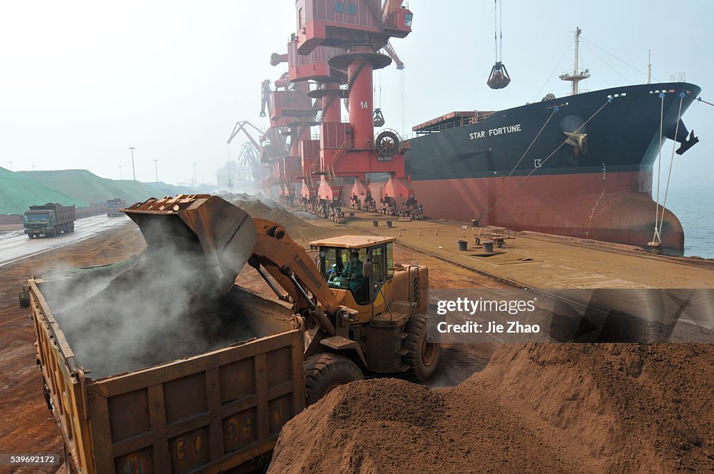 Iron ore from Australia is unloaded at Rizhao Port, one of China's biggest ports for importing the commodity, Shandong p