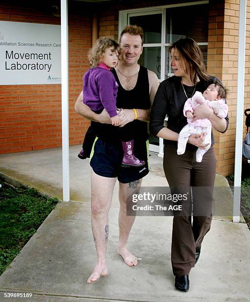 Gunshot victim Darren Stevenson has learnt to walk again. He is pictured here with his wife Tanya and daughters Katie, 2 months, and Olivia, 2 years....