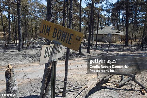 The garage is destroyed while the house remains untouched near Bastrop in the aftermath of wildfire through the piney woods in Bastrop County 30...