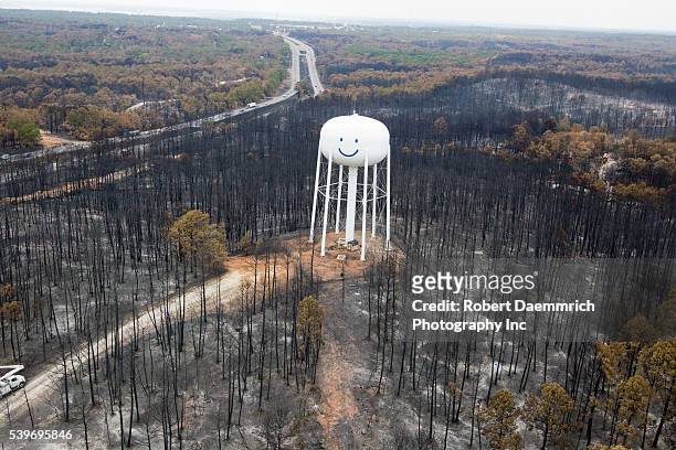 Damage to the forest and houses in the Tahitian Village subdivision of Bastrop County, TX where wildfires last week claimed 38,000 acres and over...