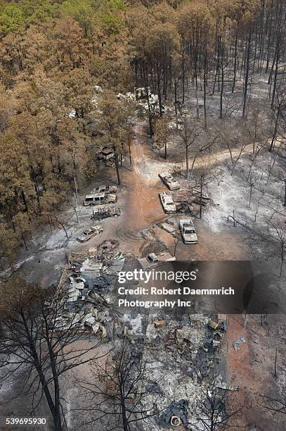 Damage to the forest and houses in the Tahitian Village subdivision of Bastrop County, TX where wildfires last week claimed 38,000 acres and over...