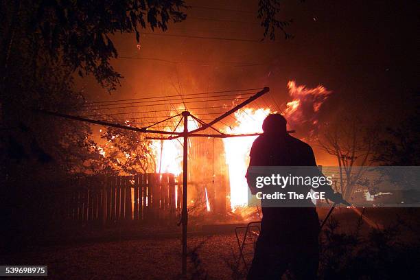 Bushfires rage through the community of Duffy, in Canberra, as residents try to save their homes, 18 January 2003. THE AGE Picture by PAT SCALA