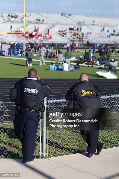 Travis County sheriffs officers watch over a Saturday track meet at Bastrop Cedar Creek High School east of Austin. Heightened security is becoming...