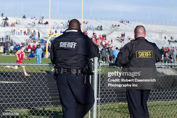 Travis County sheriffs officers watch over a Saturday track meet at Bastrop Cedar Creek High School east of Austin. Heightened security is becoming...