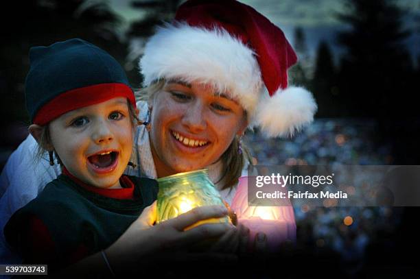 Sharon Furby of Ashtonfield with her daughter Genessa, aged 3, at Carols by Candlelight at King Edward Park, 19 December 2003. NCH Picture by DEAN...