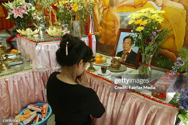 Bopha Ly prays at a shrine for Chy Pou Yeak at the Salvation and Cambodian Culture Association centre at Canley Vale. Yeak was murdered at his...