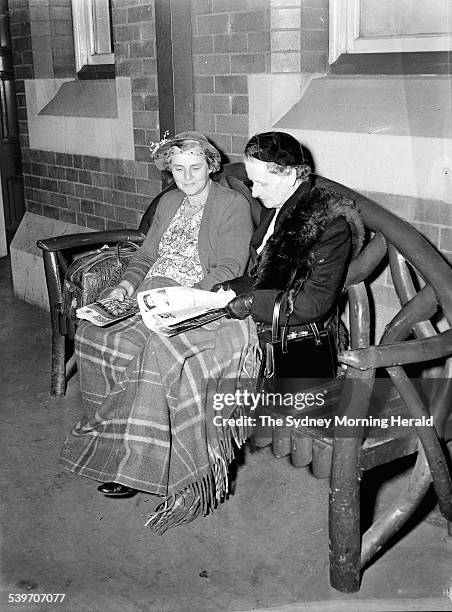 Passengers patiently wait while the train to Cooma is delayed at Central Railway Station Sydney on 18 April 1956. SMH NEWS Picture by WRIGHT...