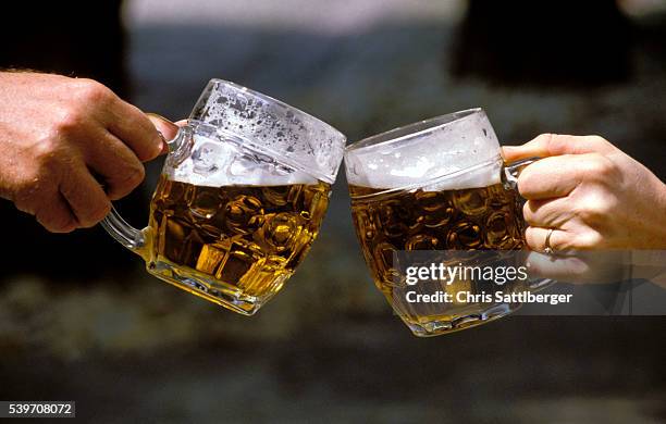 people holding beer mugs and toasting - ölsejdel bildbanksfoton och bilder