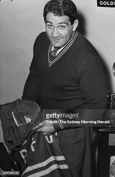 Rugby union star Nick Shehadie packs his Wallaby gear, 12 September 1957. SMH Picture by TED GOLDING