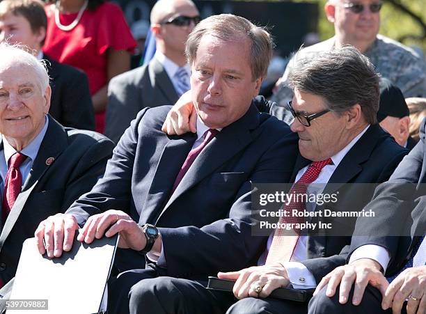 Lt. Gov David Dewhurst, l, and Texas Gov. Rick Perry embrace as thousands of Texans turn out for the Texas Capitol Vietnam Veterans Momument...