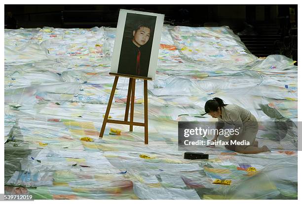 Nguyen Tuong Van. A portrait of Van Nguyen Tuong stands amongst thousands of hand out lines showing support for Van at the State Library, on 18...