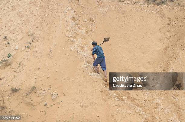 Man works at the site of a rare earth metals mine at Nancheng county, Jiangxi province October 20, 2010. China on Wednesday denied a report that the...